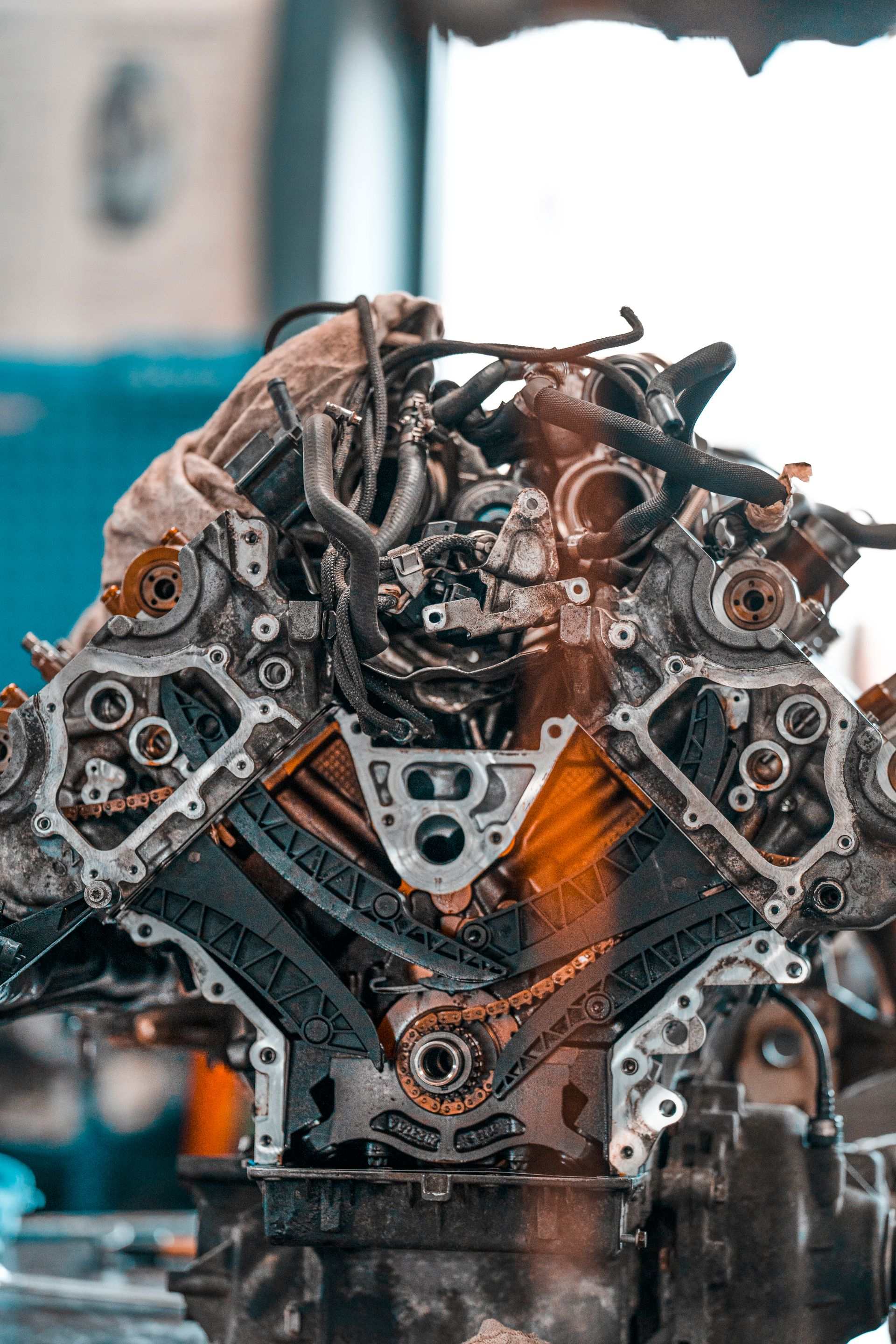 Disassembled engine block with exposed timing chains in workshop
