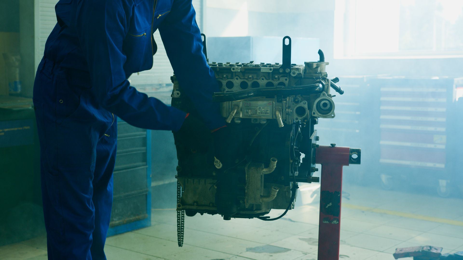 Technician working on an engine block in a workshop